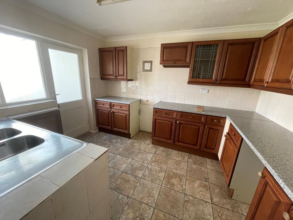 Kitchen with fitted units and access to conservato