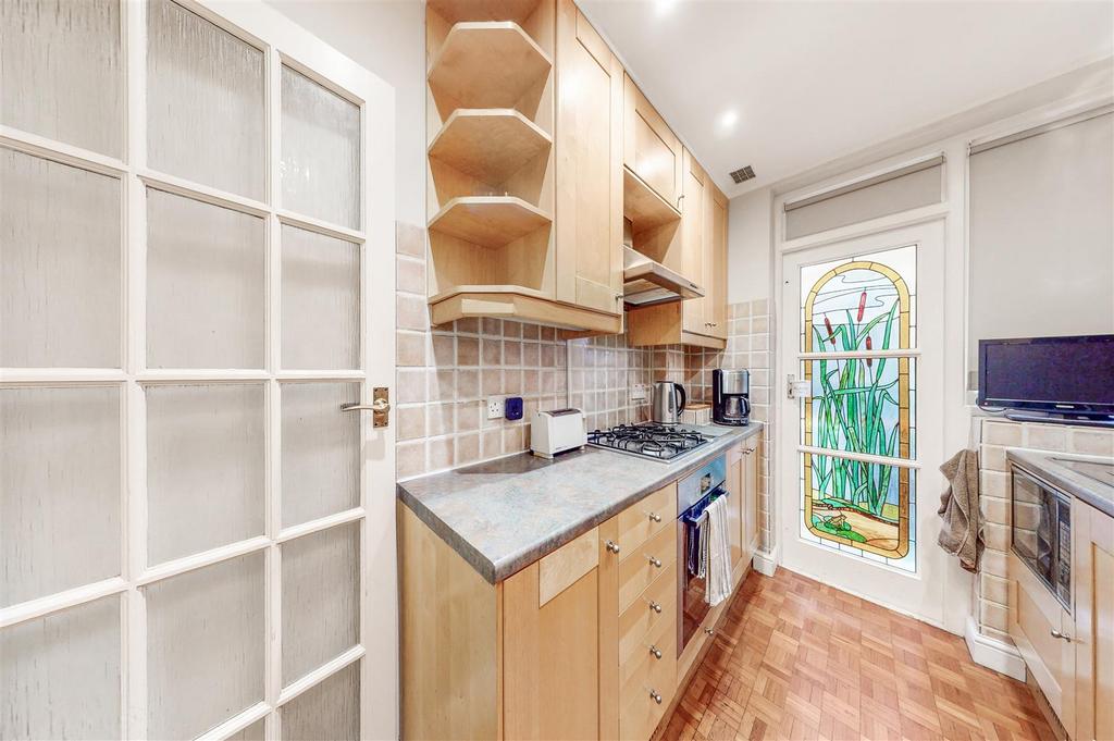 Fitted kitchen with door to garden