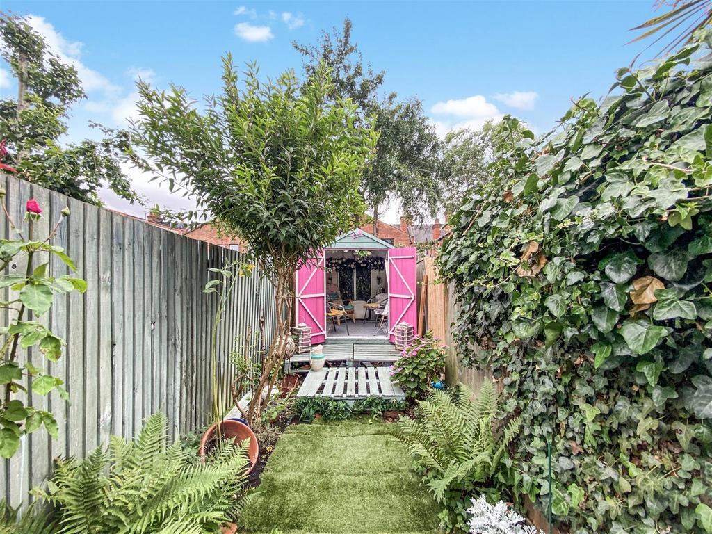 Private rear garden on two tiers with summer house