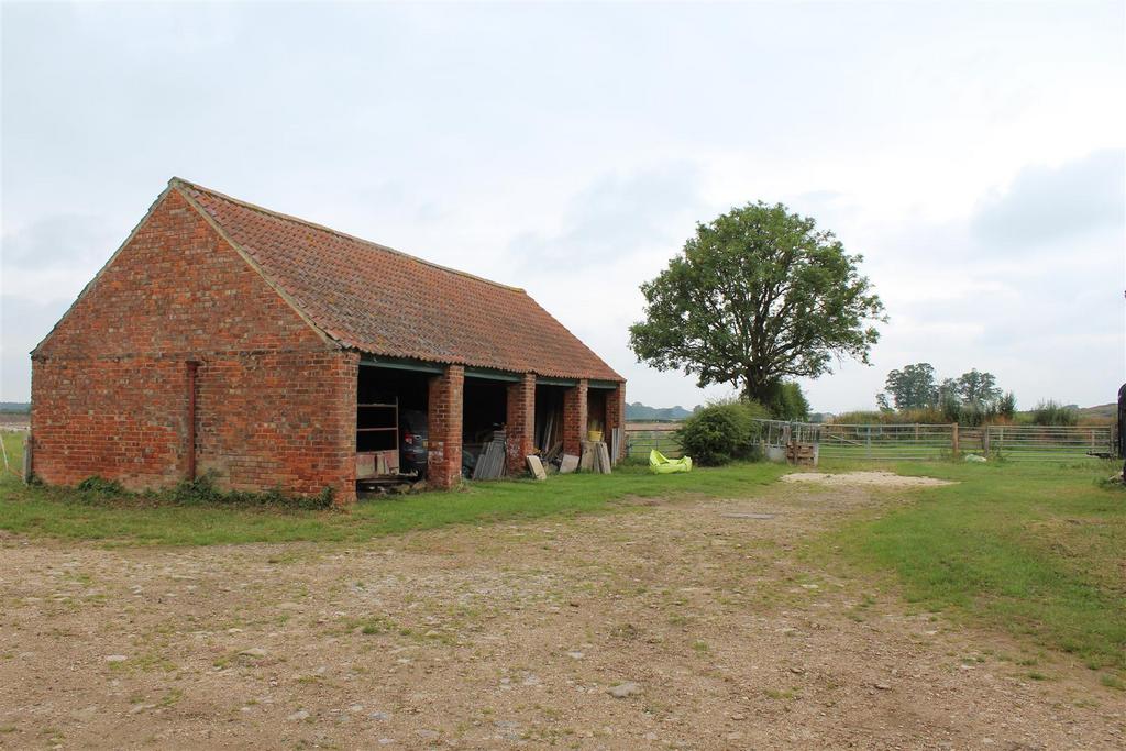 Four bay open fronted cart shed