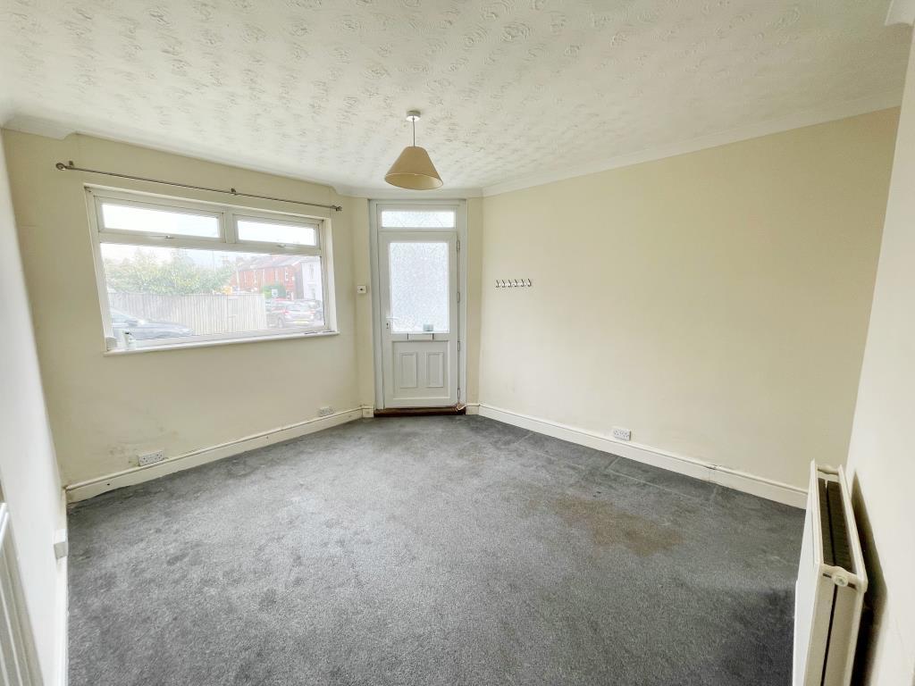 Living room with beige walls and grey carpet