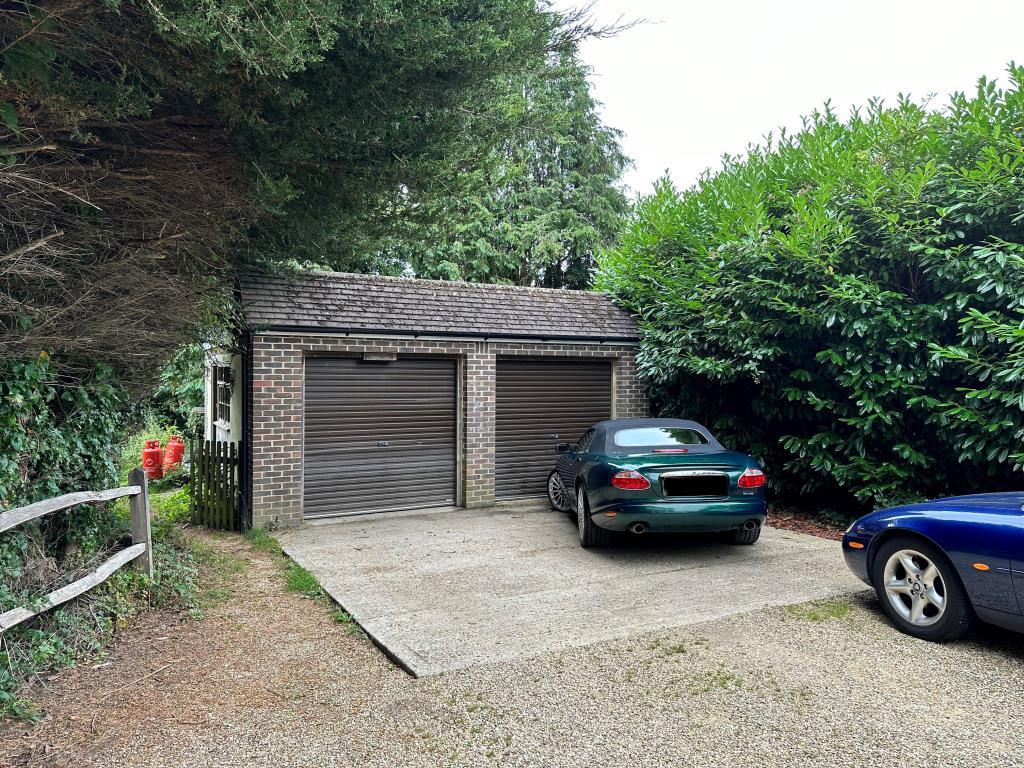 Double brick garage and doors with driveway