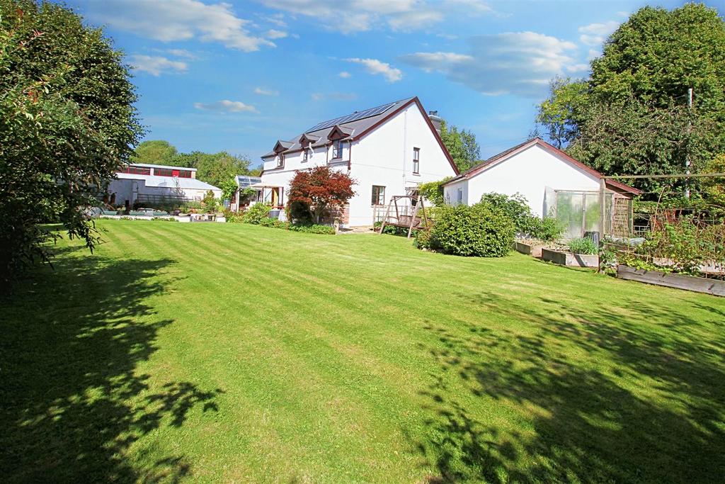 Rear gardens and view of house