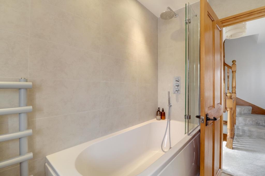 Family bathroom that includes an integrated bath a