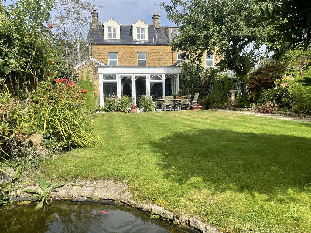 Garden and rear of house over pond.JPG