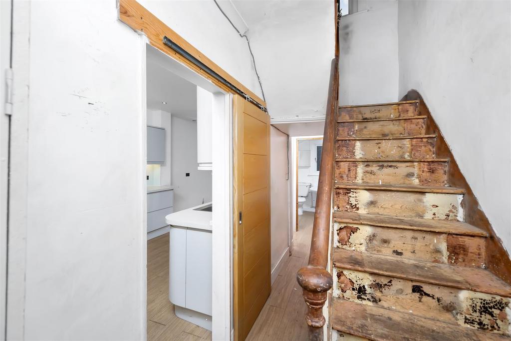 Stairs rising to First Floor