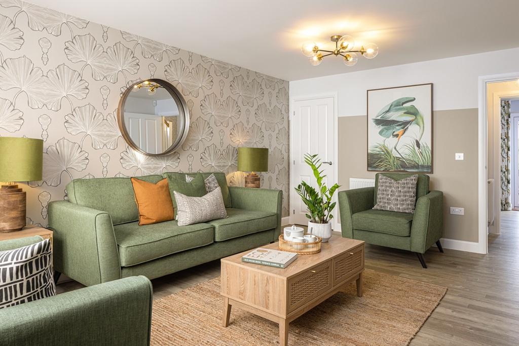 Living room with green sofa in a 3 bedroom home