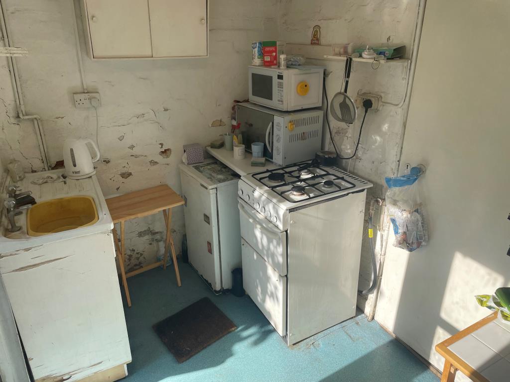 Kitchen with cooker and sink