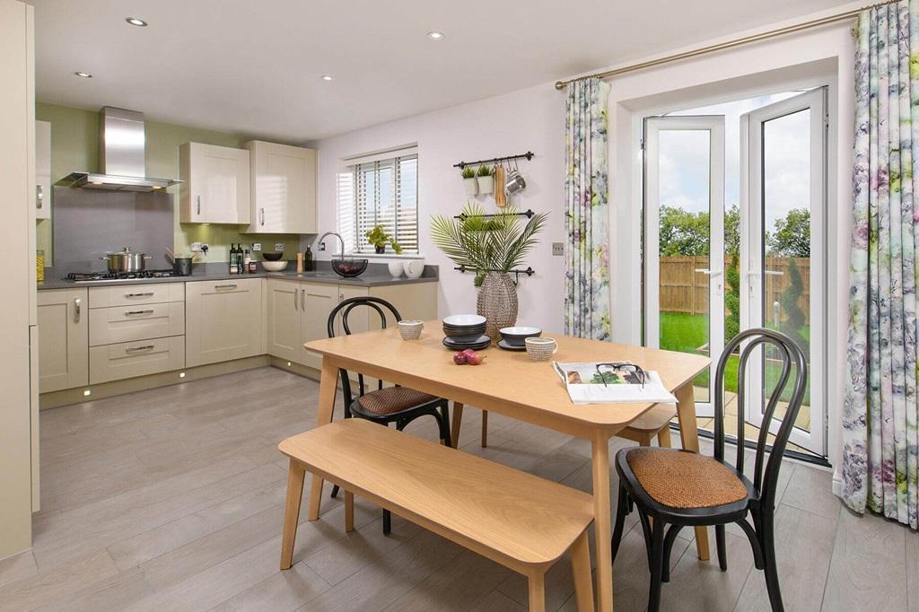 An open plan kitchen and dining area leads...