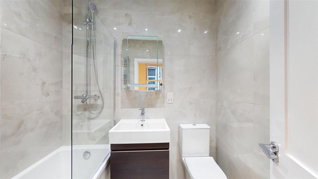 Fully tiled family bathroom