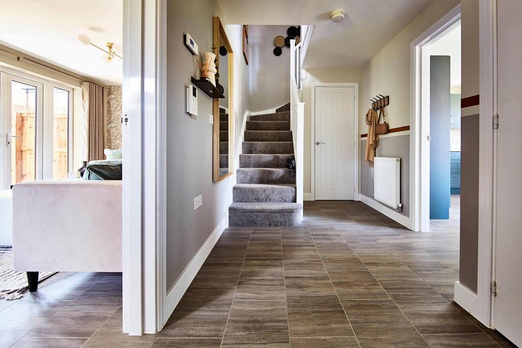 A welcoming hallway sits central to the home  ...
