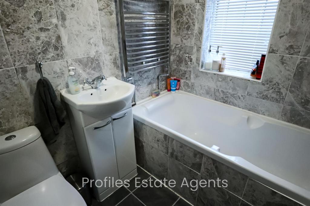 Modern bathroom Front) Fully tiled.