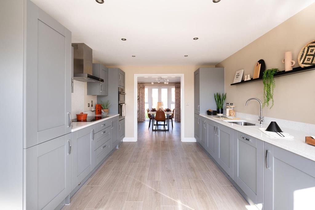 The kitchen leads through double doors to the...