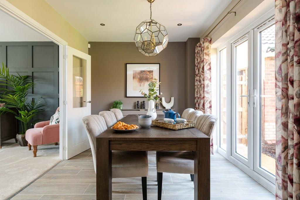 Traditional dining room with French doors to...