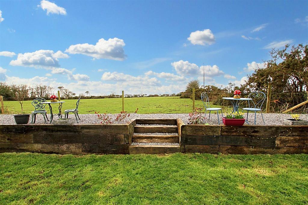 Steps up to gravelled seating area
