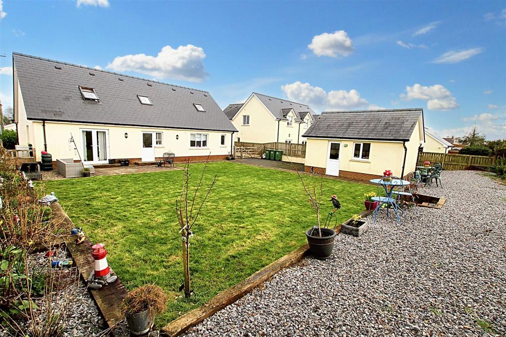 Rear garden and view of house