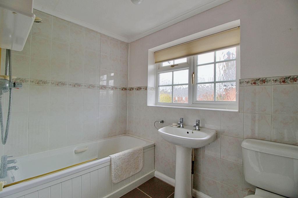 Family bathroom with shower over bath
