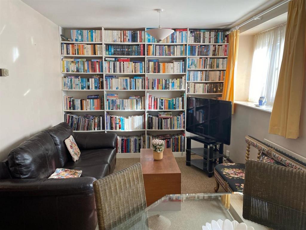 Living Area with built in floor to ceiling shelvin