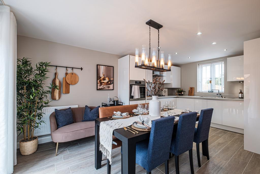 Modern kitchen with white cupboards and dining...