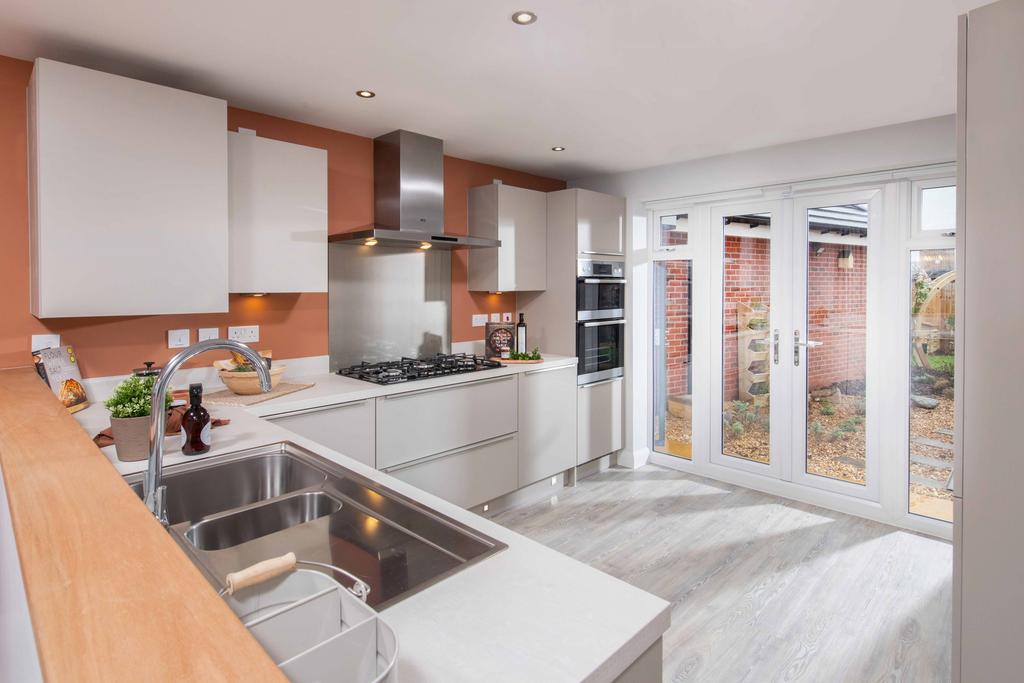 Modern kitchen with French doors in the four...