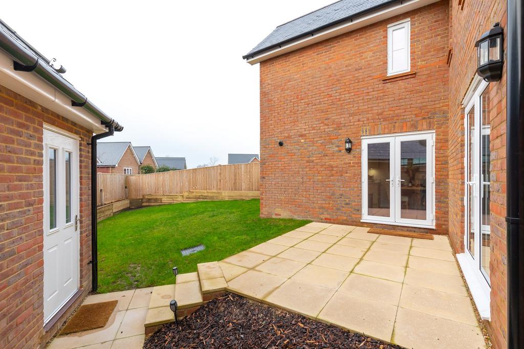 Garden with patio area and raised beds