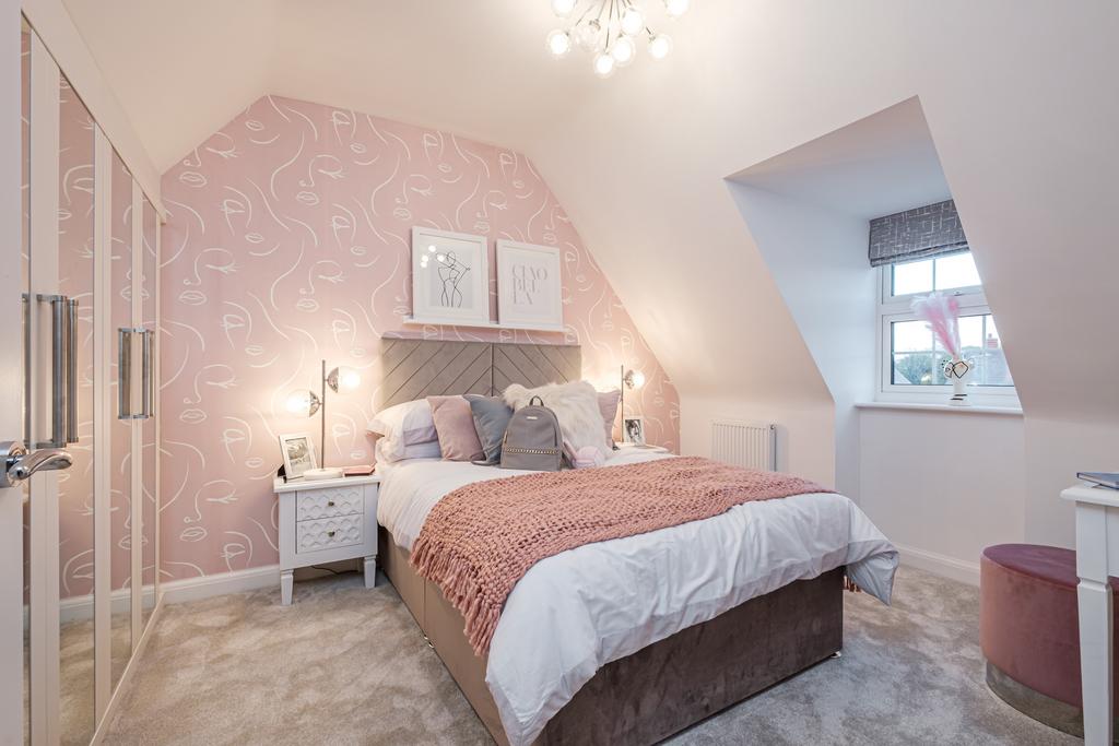 Child&#39;s bedroom with pink wallpaper