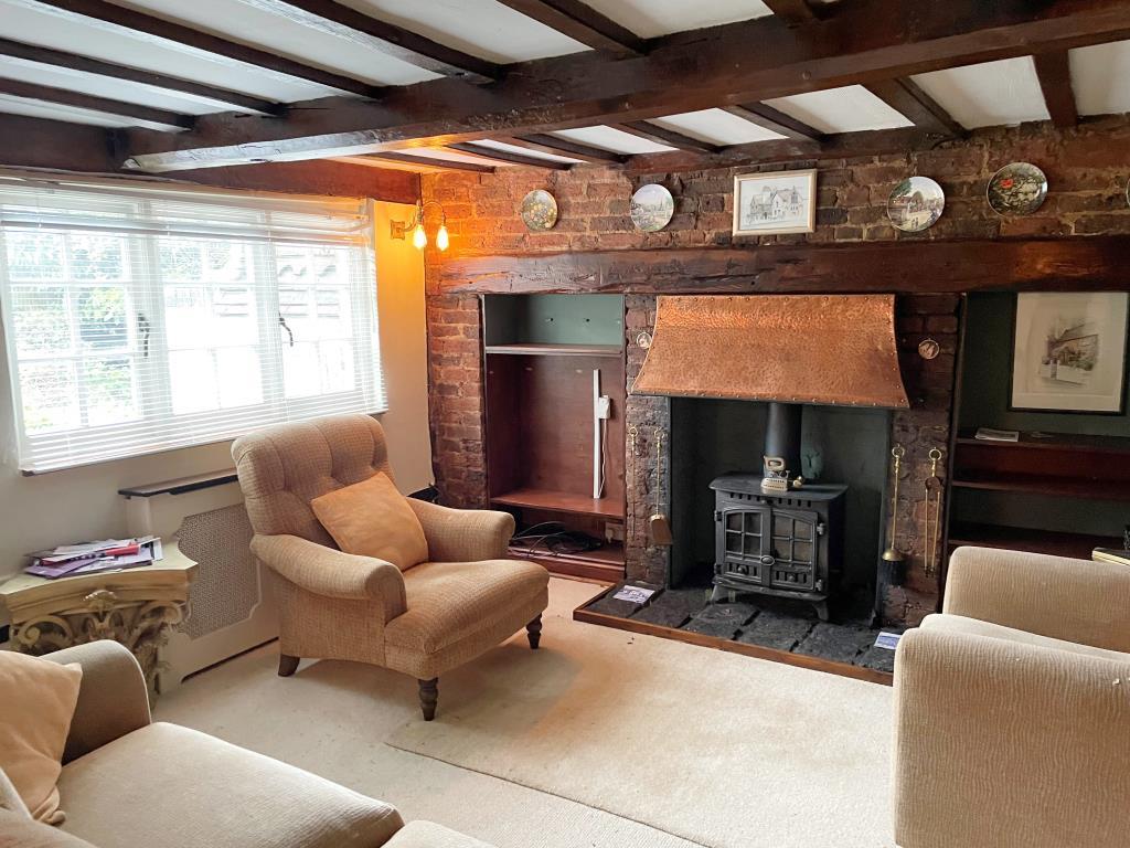 View of living room with beams and fireplace