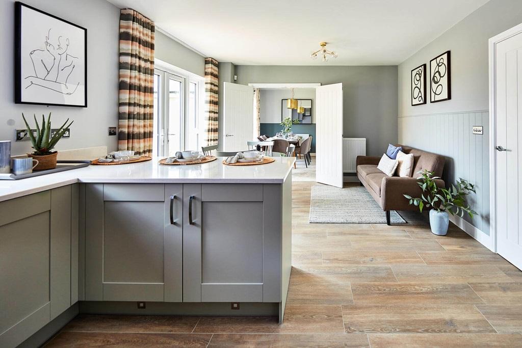 An open plan kitchen and dining area leads...