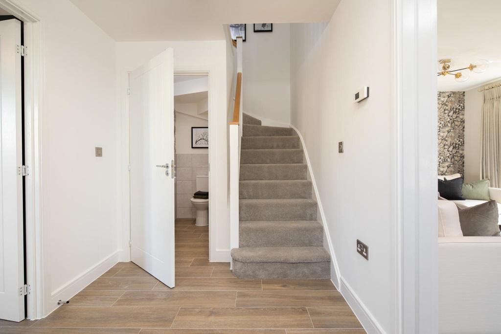 A welcoming hallway with storage and downstairs...