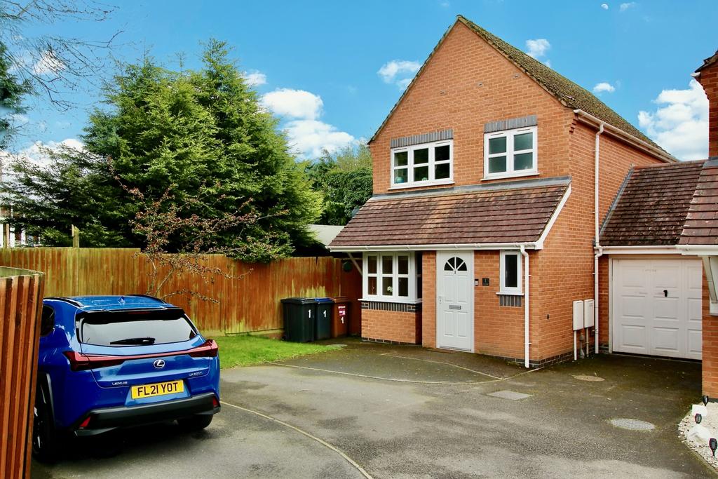 View of property at the front with garage and park