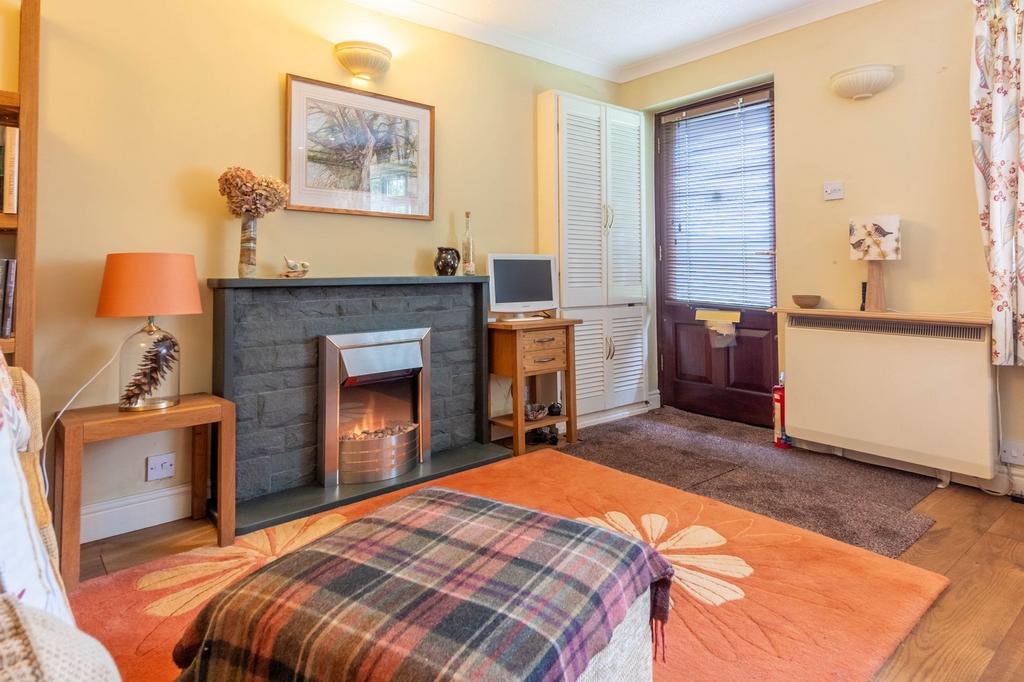 Open plan living area with kitchen off to the side