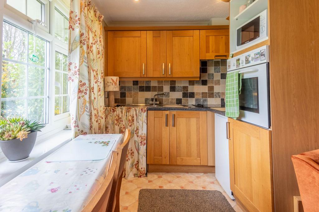 Open plan living area with kitchen off to the side