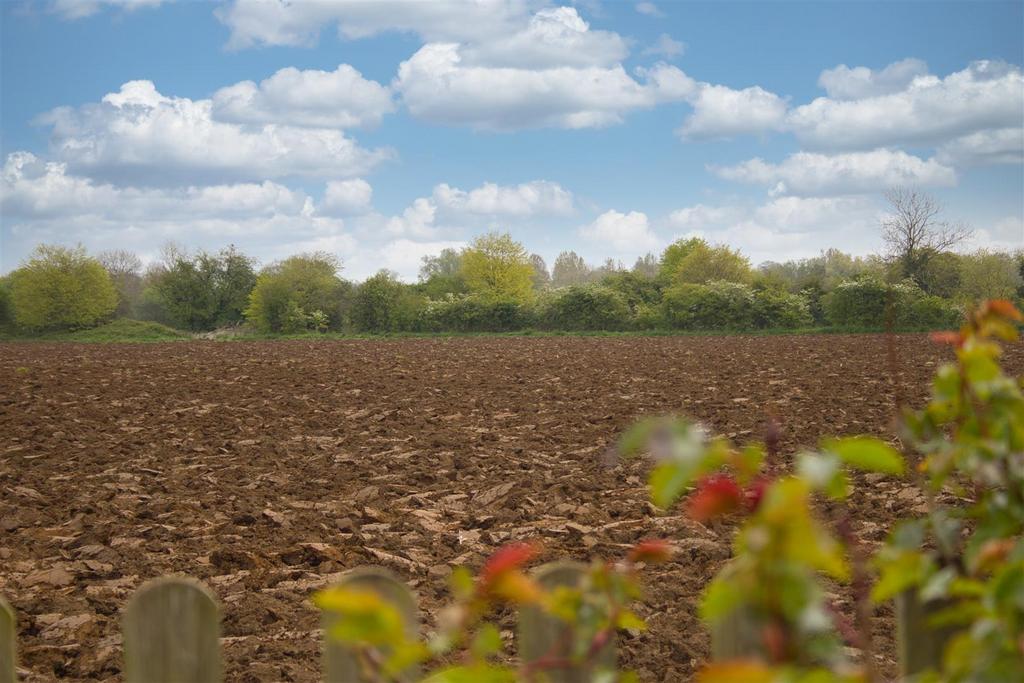 Ploughed fields to rear