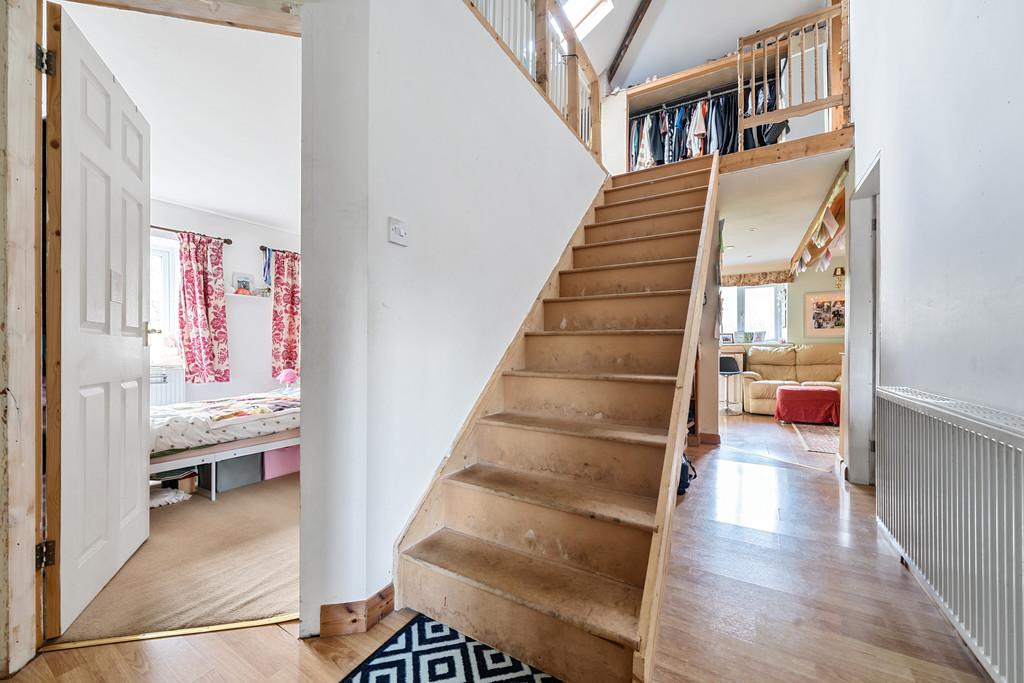 Hallway with staircase to attic room