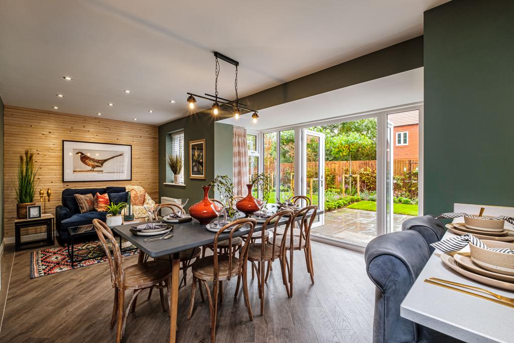 Open plan kitchen with dining table and French...