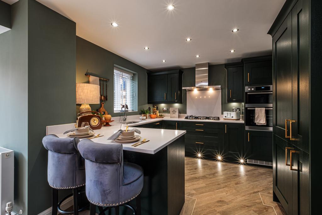 Kitchen with dark cupboards, wooden floor and a...