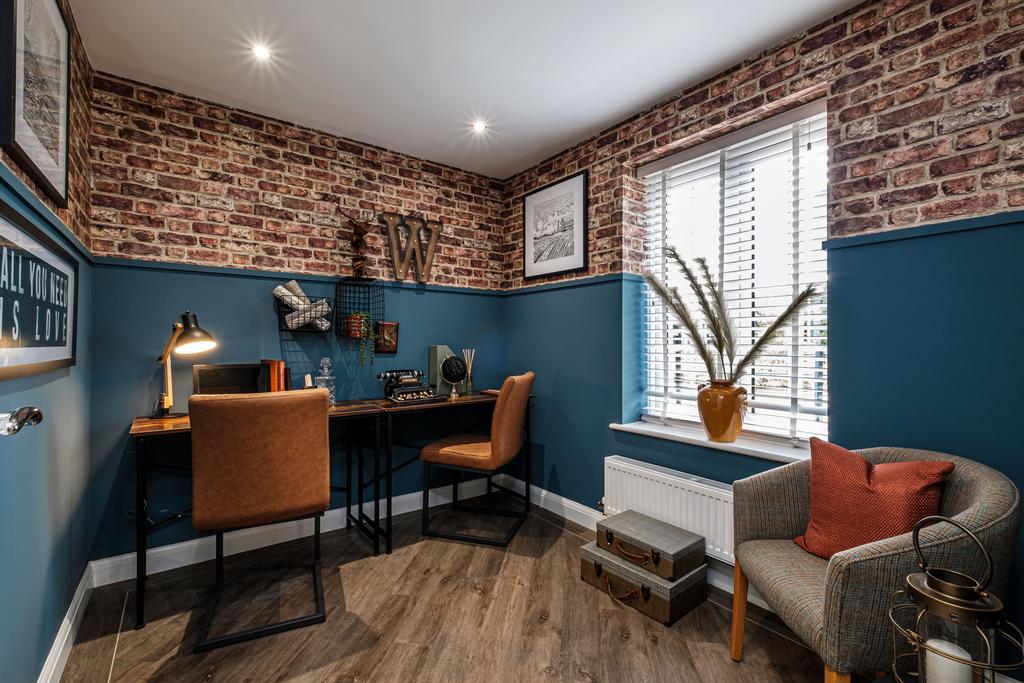 Study with brick patterned wallpaper above blue...