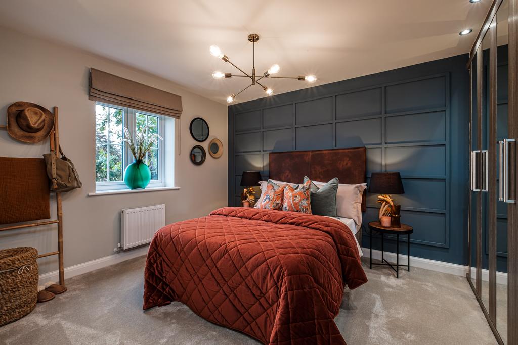 A large double bedroom with blue panelled wall