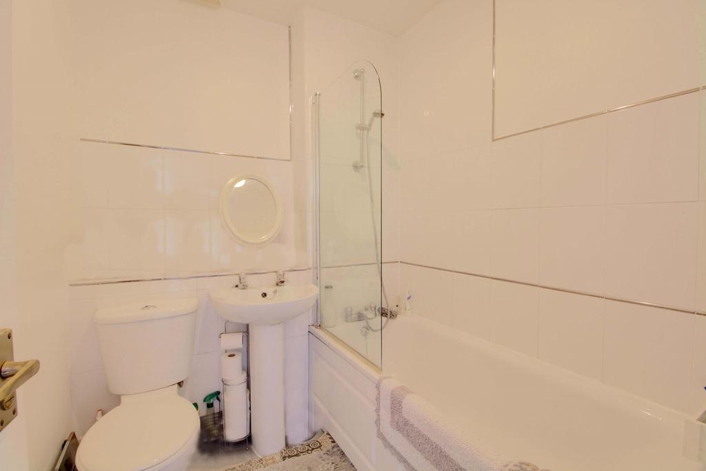 A screened mains shower over full sized bath White