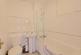 A screened mains shower over full sized bath White