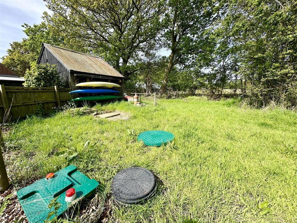 Garden to side with treatment plant drainage.JPEG