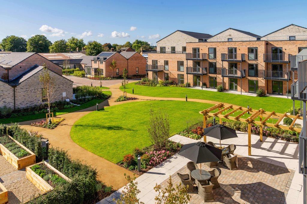 Village green and communal garden with large...