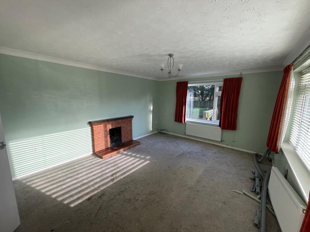 Living room with fireplace and dual aspect windows