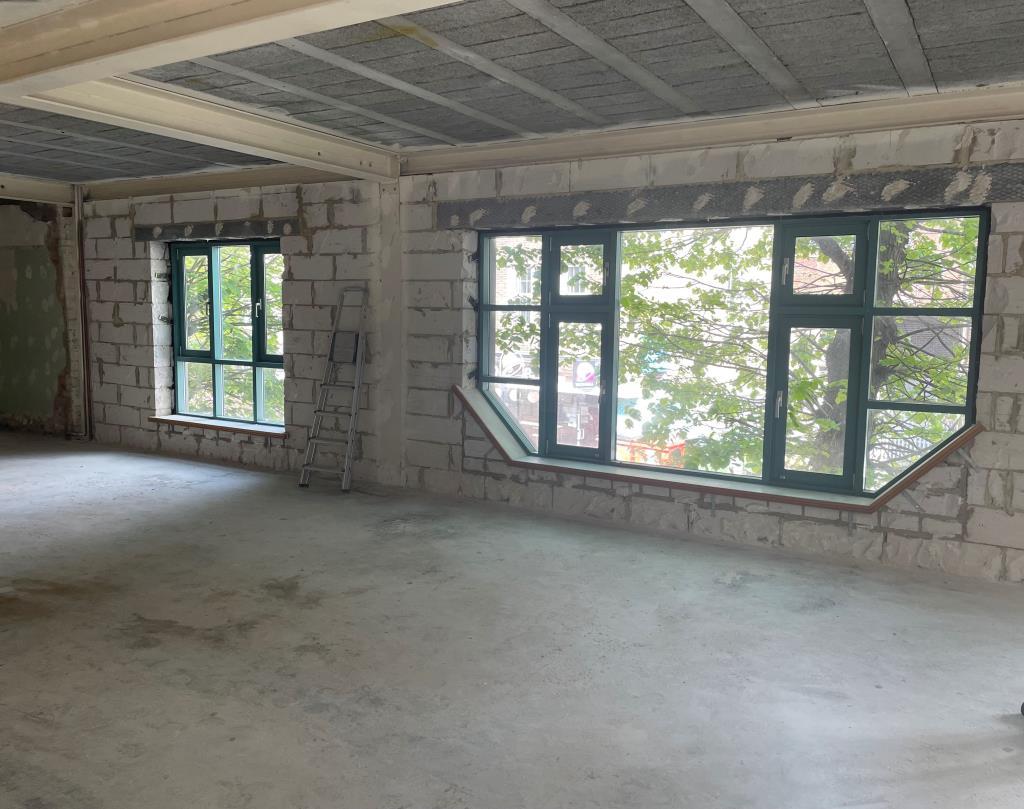 Open plan second floor area with front windows