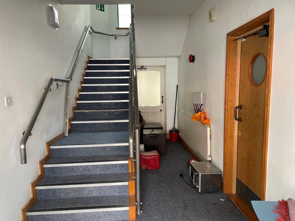 Ground floor front entrance with central staircase