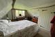 Bedroom 2 with exposed beams and window to side