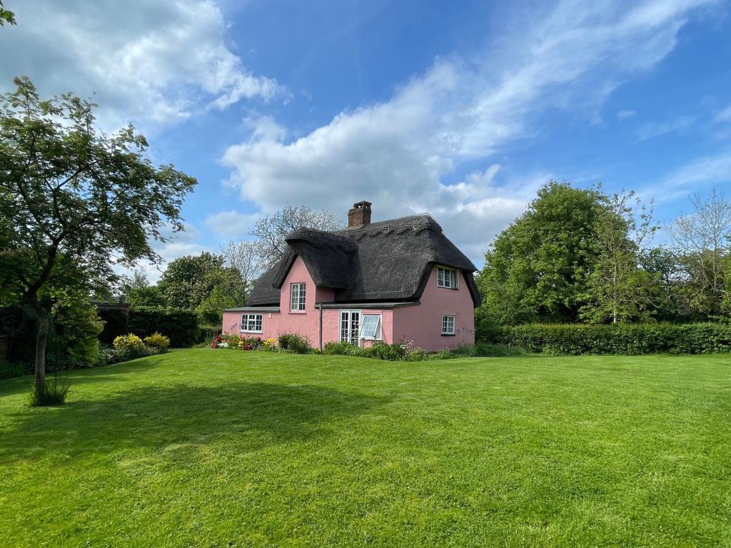 Rear view of the property and garden