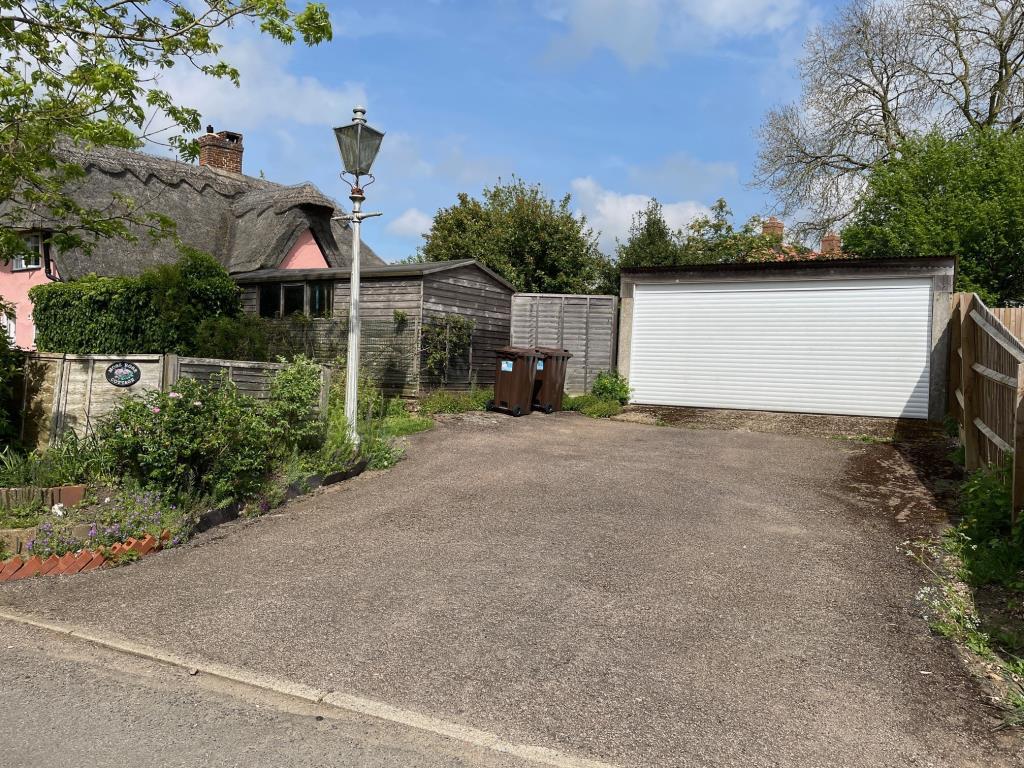 Driveway parking, double garage and shed to the re