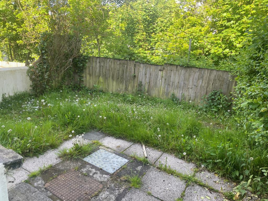 Rear garden with patio area and area of grassland