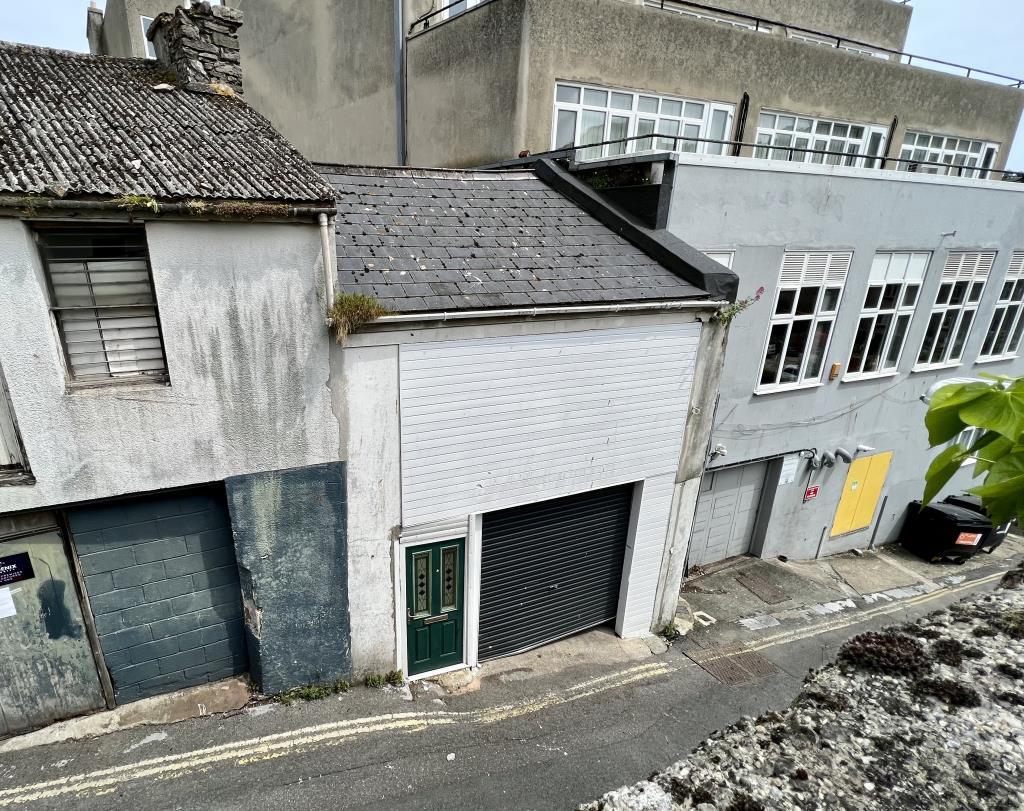 General view of the rear garage and store from Tem